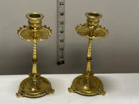 A pair of antique brass candlesticks