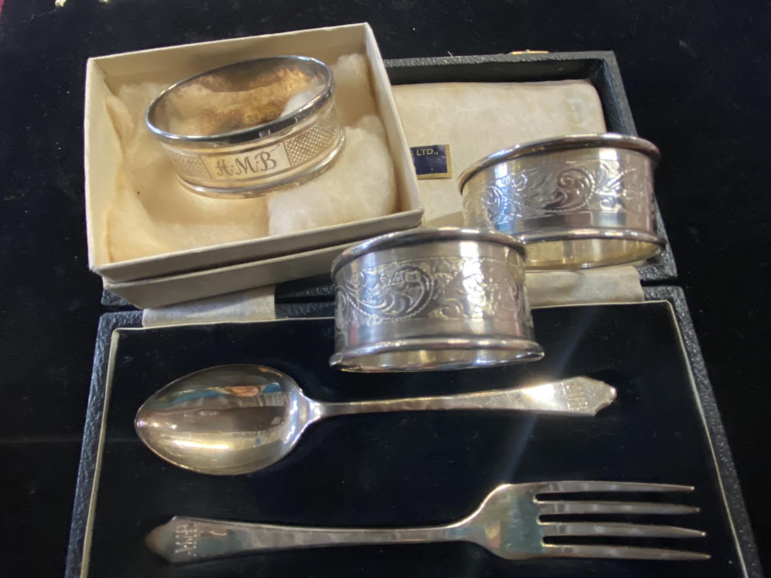 Three hallmarked silver napkin rings and a hallmarked silver spoon and fork set gross weight 67g