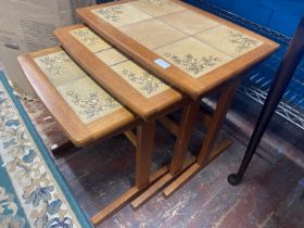 A nest of three mid century teak tables with tile inserts, 53x39cm shipping unavailable