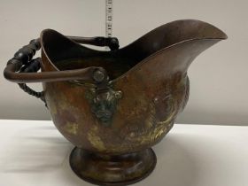 An antique copper coal bucket