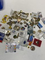 A large selection of assorted pin badges etc