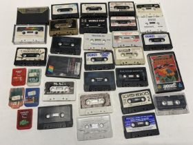 A box of loose spectrum gaming cassettes and other