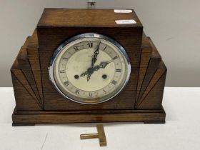 A Art Deco period oak cased mantle clock by Enfield with key and pendulum