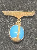 A stamped 14ct gold brooch with turquoise stone