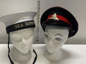 A military cap and a sea scouts hat
