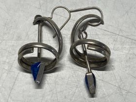 A large pair of unusual white metal earrings
