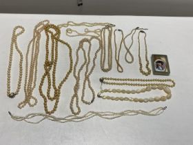 A selection of assorted simulated pearl necklaces and other