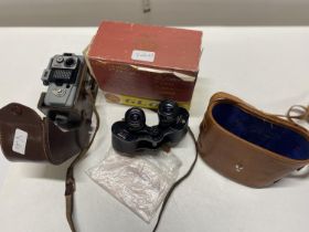 A pair of vintage prismatic binoculars and a Eumig camera