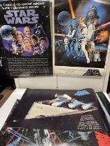 A selection of Starwars posters, A Starwars trilogy video boxset and Back to the Future trilogy