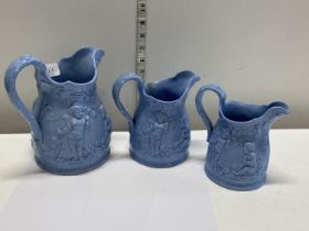 Three blue glazed graduated Victorian jugs one with slight crack