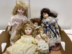 A box of assorted vintage dolls
