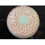 A circa 1850 Bacchus paperweight with millefiori decoration with red canes and seven central blue