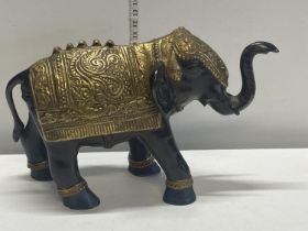 A very heavy bronze hollow cast Oriental elephant with gilt decoration weighs 11kg 35x52cm
