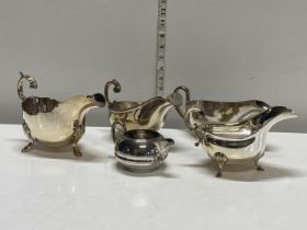 A selection of silver plated creme jugs and sauce boats including Walker and Hall