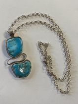 A 925 silver chain and pendant with blue stone decoration