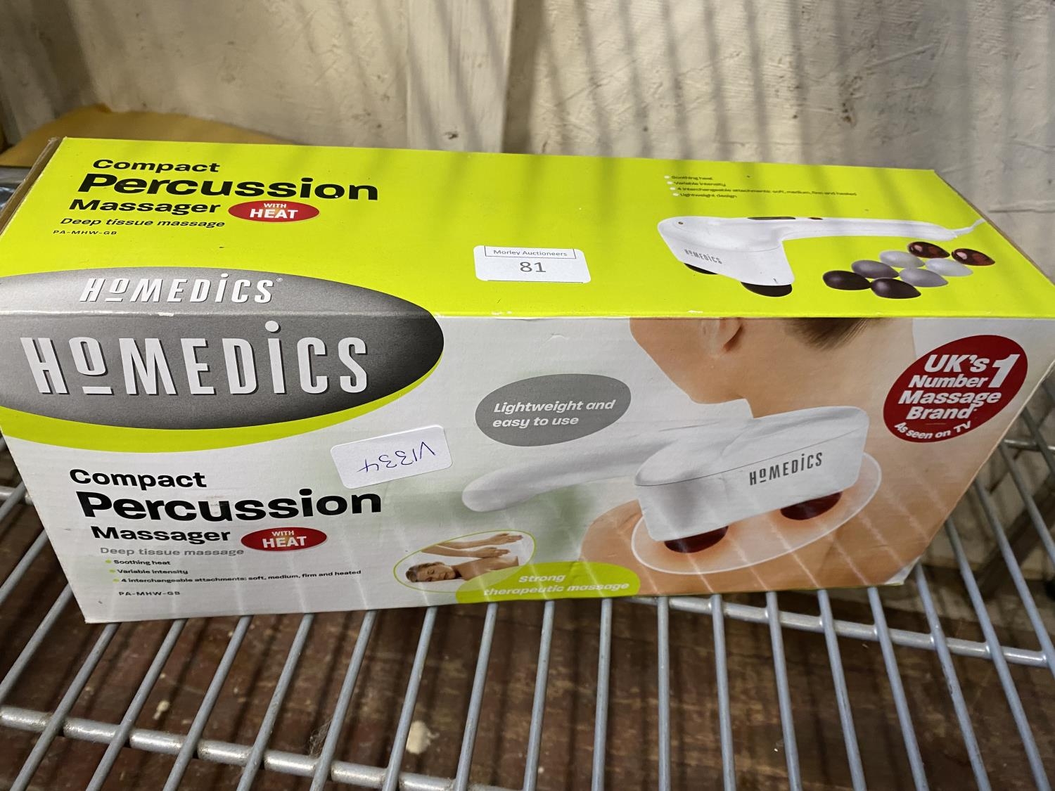 A boxed as new compact percussion massager