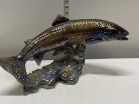 A large ceramic figure of a leaping salmon with lustre effect