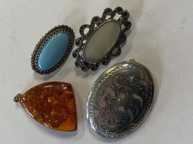 A selection of 925 silver pendants and one amber pendant