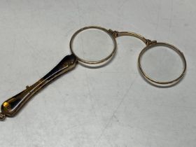 A pair of gold plated spectacles with faux tortoise shell handle