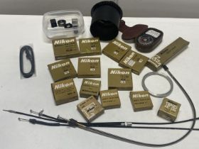 A job lot of boxed Nikon filters and other accessories