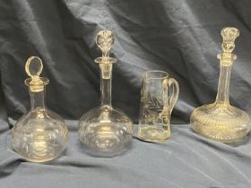Three Victorian glass decanters and a hand blown glass jug