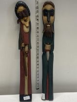 A pair of hand carved wooden Malin Artisticos figures