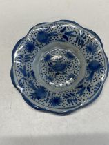 A 17th century delf blue and white lobed dish with fruit decoration (has large crack)