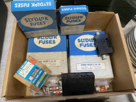 A box of vintage electrical accessories including fuses etc