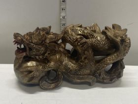 A hand carved wooden Chinese Dragon with puzzle ball feature at the front