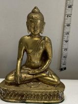 A heavy brass figure of a seated Budda