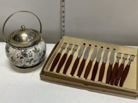 A antique ceramic biscuit barrel and a set of vintage cutlery