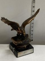 A heavy bronzed sculpture of a eagle