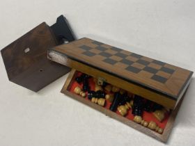 A wooden travelling chess set and a vintage tea caddy