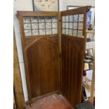 A antique clerics privacy screen with glazed and carved panels, shipping unavailable