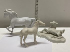 A selection of white ceramic horses including Royal Doulton