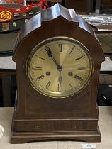 A mahogany cased mantle clock with brass dial