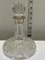 A hallmarked silver collared small decanter