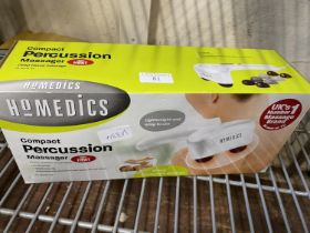 A boxed as new compact percussion massager
