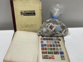 A stamp album and selection of loose stamps with a Rolls Royce diesel manual