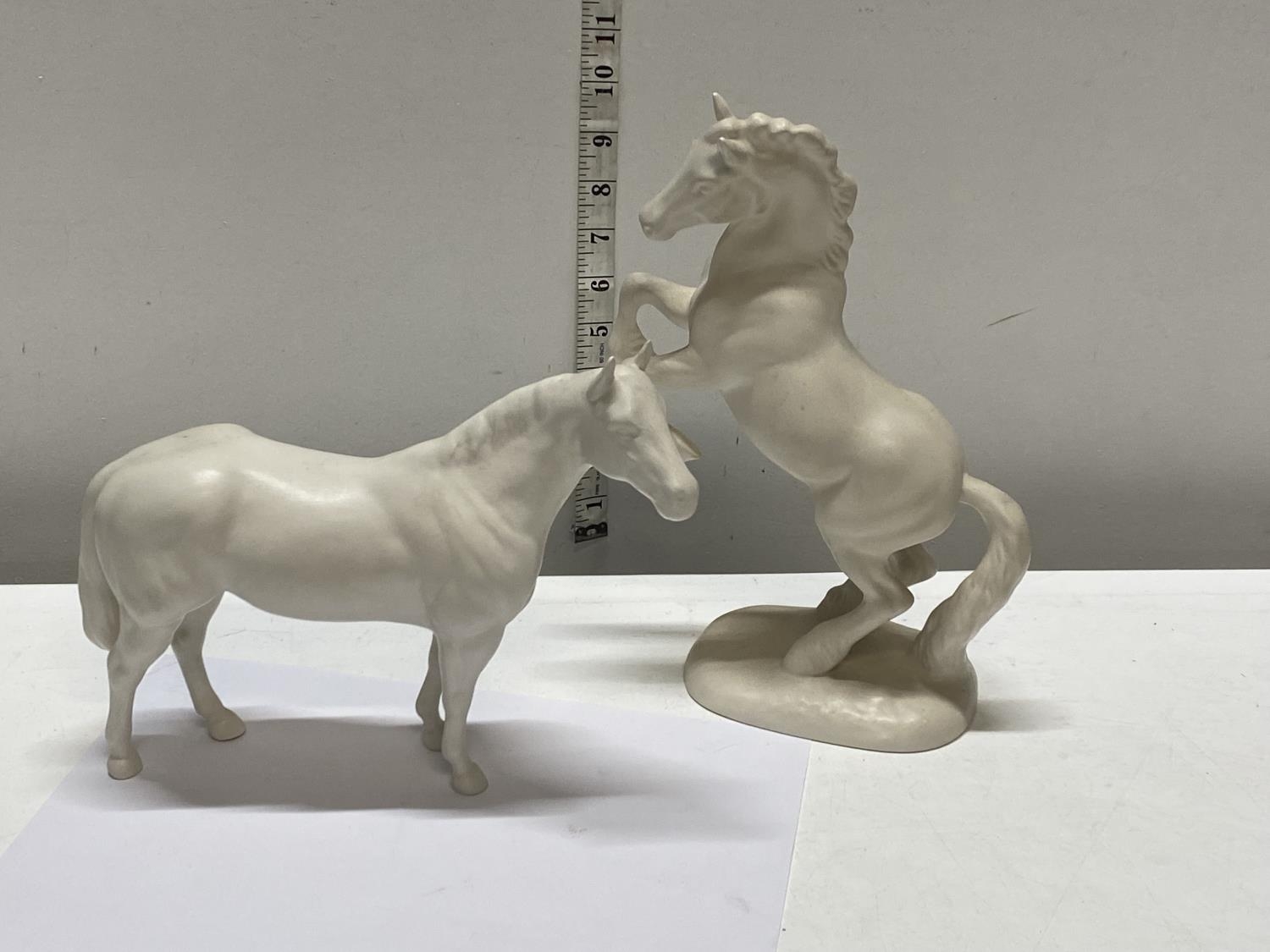 Two Beswick white horses