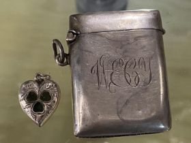 A hallmarked silver vesta case and small heart locket