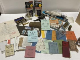 A job lot of assorted collectables including rifle scope, brass desk cannon and military documents