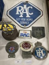 A vintage RAC enamel sign and collection of assorted car bumper badges
