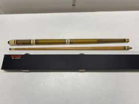 A vintage pool cue and a BCE cue case