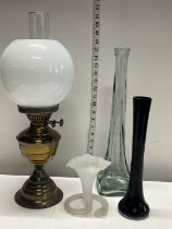 A vintage brass and glass oil lamp with a selection of art glass. Shipping unavailable