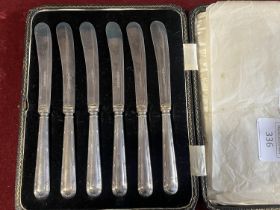 A set of six cased hallmarked silver handled butter knives