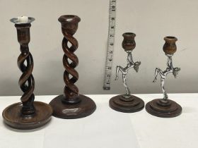 A two treen candle sticks and two art deco chrome lady candle sticks