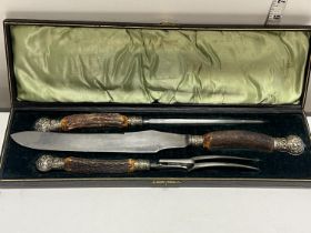 A boxed antique horn handled carving set by John Mcglory and Sons Sheffield