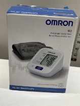A boxed Omron blood pressure monitor (untested)