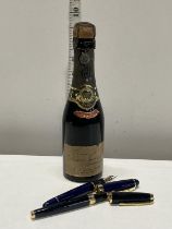 A sealed bottle of vintage Perrier - Jouet Champagne h22cm. And two fountain pens